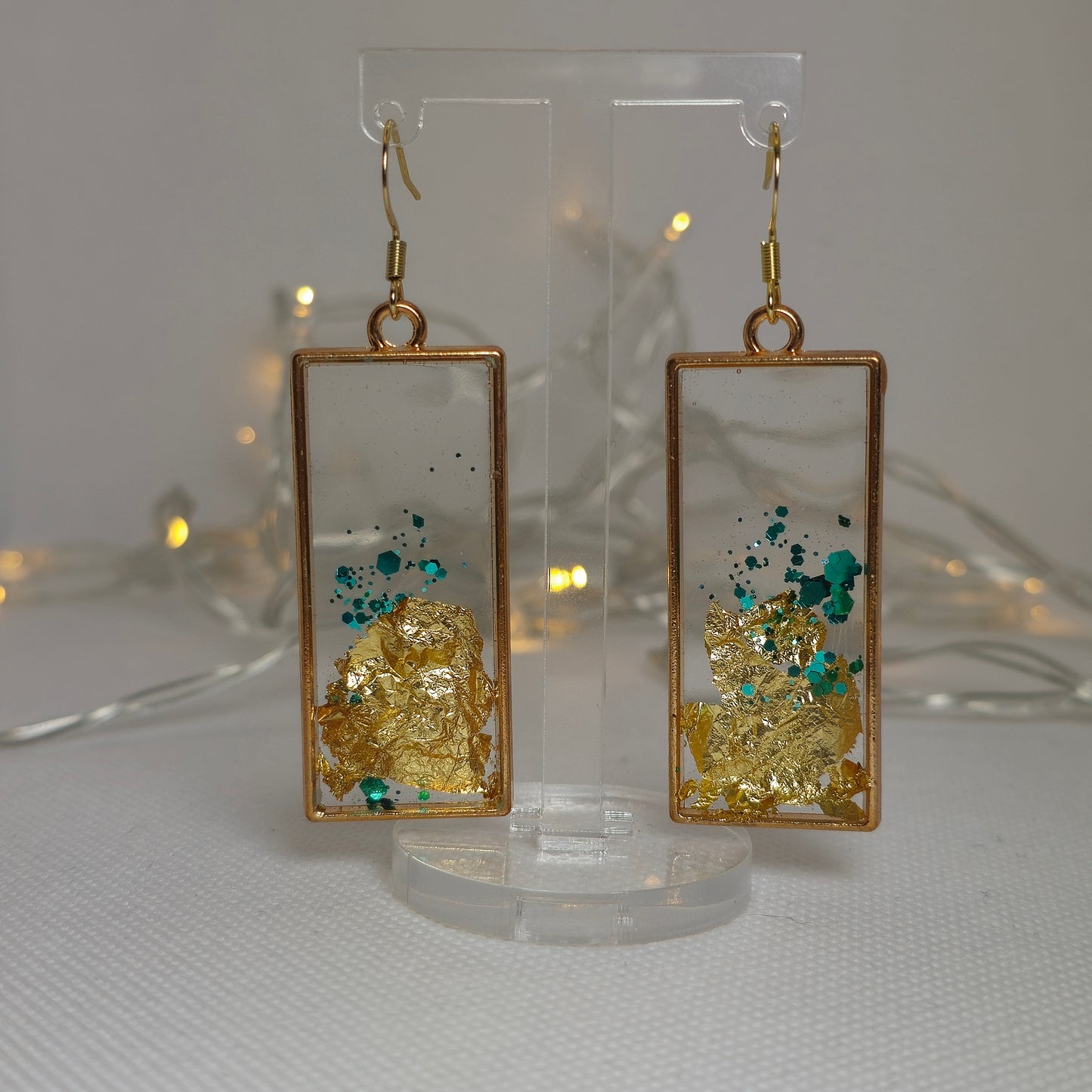 Earrings - Acrylic resin encasing gold leaf and turquoise glitter in a gold rectangular frame
