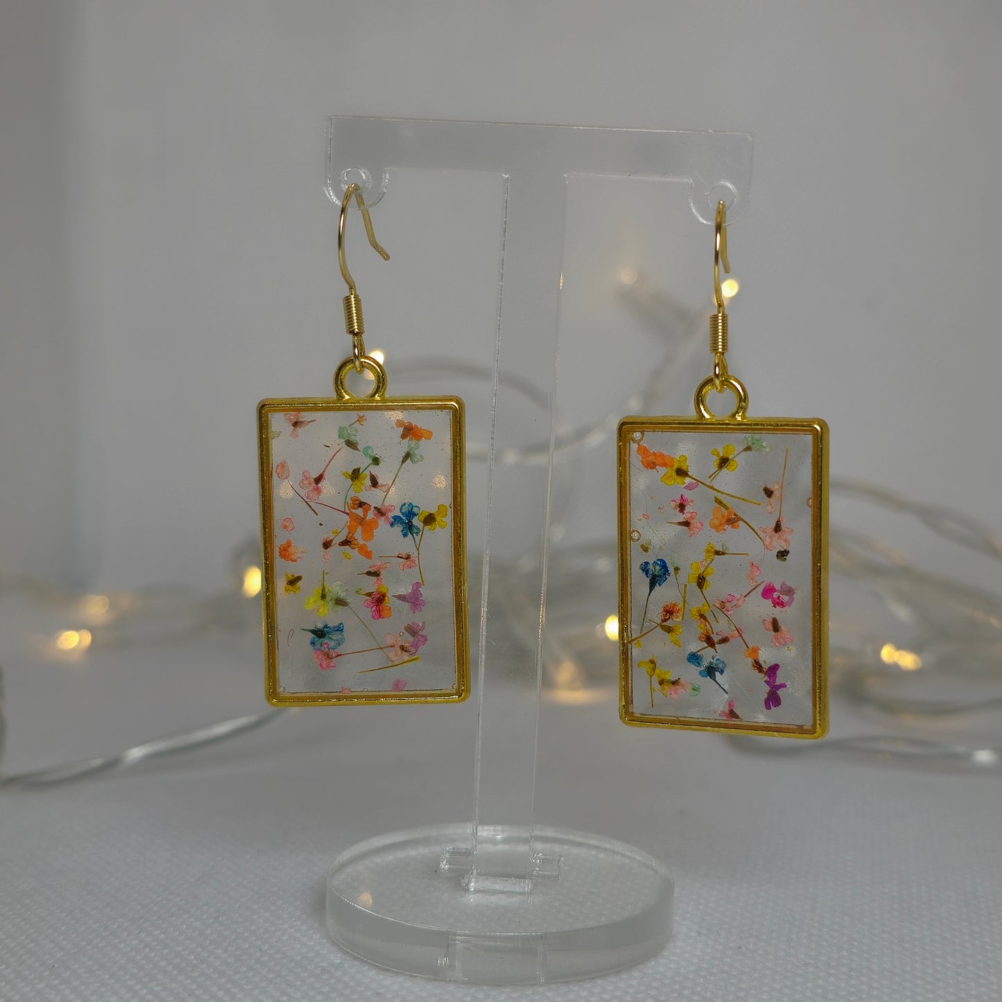 Earrings - Acrylic resin, tiny multi colour flowers encased in clear resin framed in a rectangular gold frame