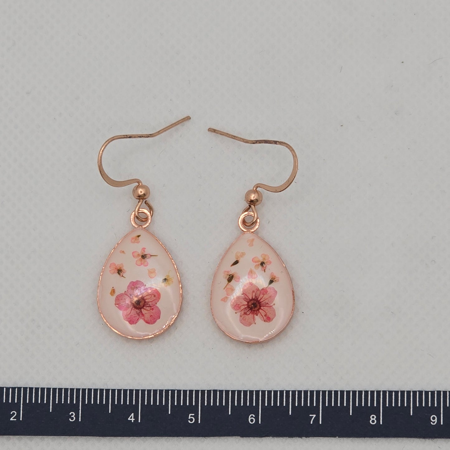 Earrings - Small bouquet of yellow Queen Anne's Lace flowers, in a round stainless steel bezel on a bed of white acrylic resin