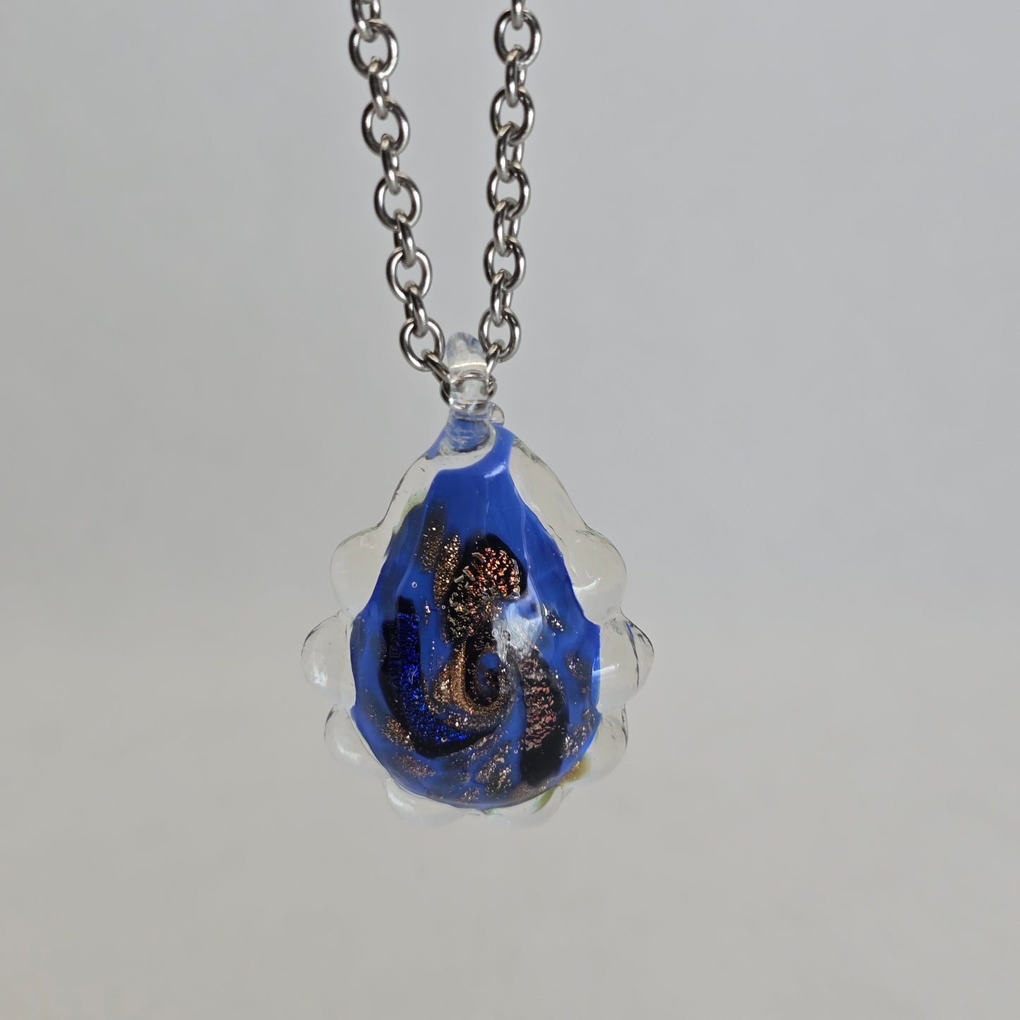 Dichroic glass pendant, irregular oval-shaped