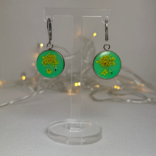 Earrings - Acrylic resin dangle earrings with tiny yellow flowers laid on a light green resin base