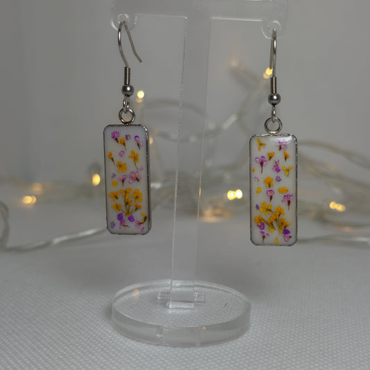 Earrings - resin-filled rectangular tray filled a sprinkling of delicate Queen Anne's lace flowers in orange and purple, on a bed of white