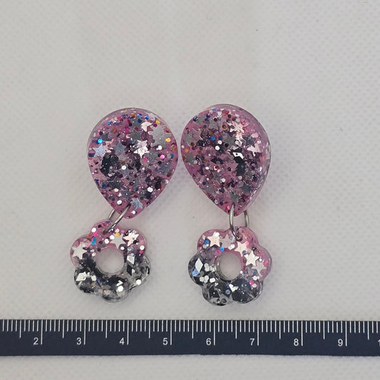 Glitter-filled pink and grey dangly earrings with chunky glitter and silver stars.